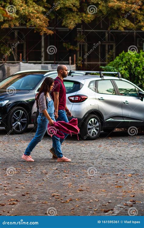 Couple Walking Between The Cars In A Parking Lot In Bucharest Romania 2019 Editorial Photo
