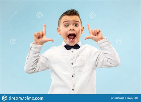 Isolated On Blue Young Casual Boy Shouting At Studio Stock Photo