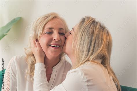 Happy Mature Mother And Grown Up Adult Daughter Hugging Share Close
