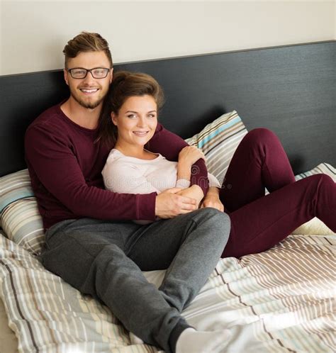 Cheerful Couple Lying On A Bed At Home Stock Image Image Of Feelings