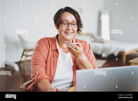 Adult Charming Brunette Woman In Glasses Plus Size Body Positive Working With Laptop At Home