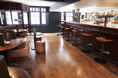 Interior Of Empty Bar With Stools And Counter Stock Photo By Monkeybusiness
