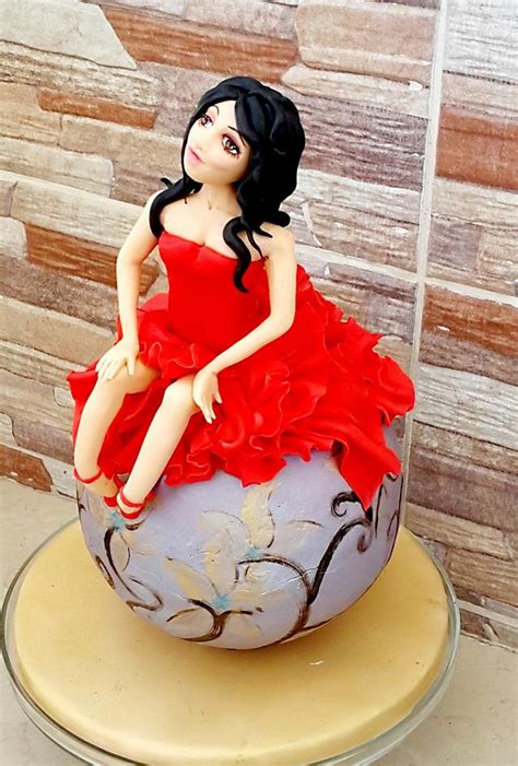 women in red decorated cake by nivo cakesdecor