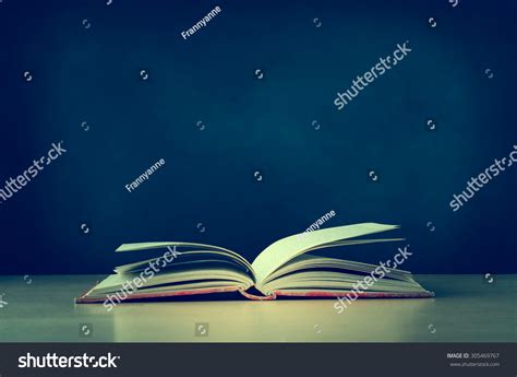 An Old Worn Fabric Covered Red Text Book Lying Opened On A School Or