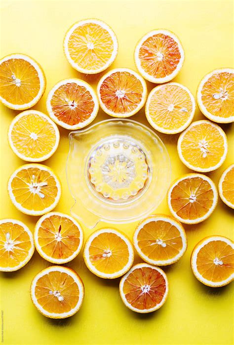 Oranges On A Yellow Background Half Oranges And A Juicer On A Yellow