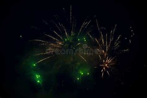 Multiple Bright Orange And Green Colorful Fireworks Explosion In The