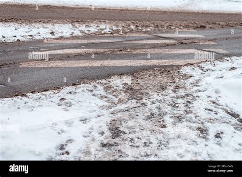 Winter In City Of Zebra Pedestrian Crossing Dirty Snow Tracks Auto Car