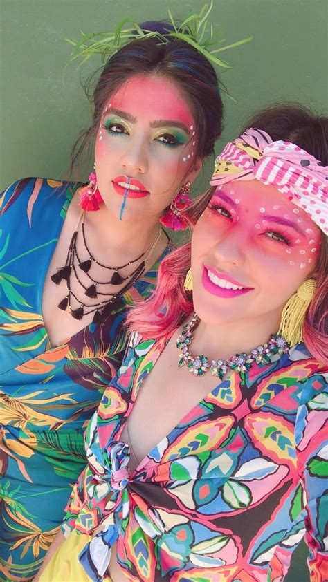 Two Women With Face Paint Posing For The Camera