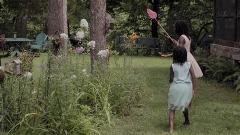 Slow Motion Of Two Black Girls Trying To Catch A Butterfly With A Net