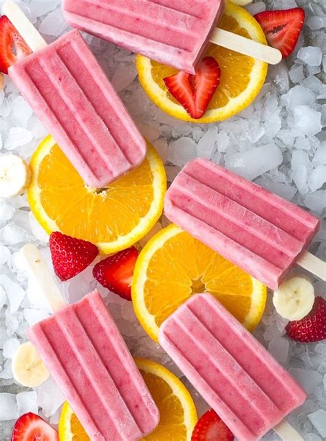 Popsicles With Fruit And Bananas On Them Sitting On Ice Next To Sliced