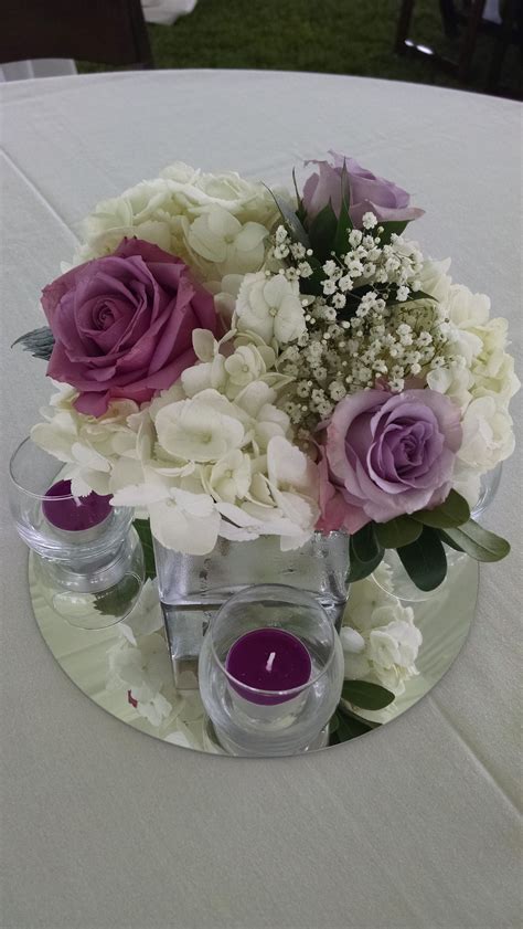Loved It Pinned It A Blooming Envy Design Centerpiece With White Hydrangeas Purple Roses