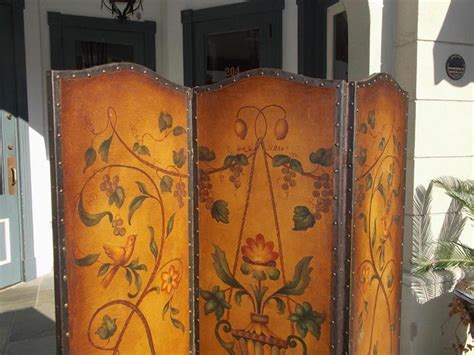 The back of the folding screen has a solid black finish. Italian Leather Arched Three-Panel Floral Vine and Urn ...