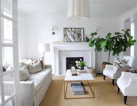White and brown living room features a Barbara Barry Simple Scallop