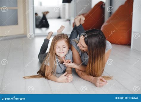 mother and daughter lying on the floor and look at each other stock image image of feelings