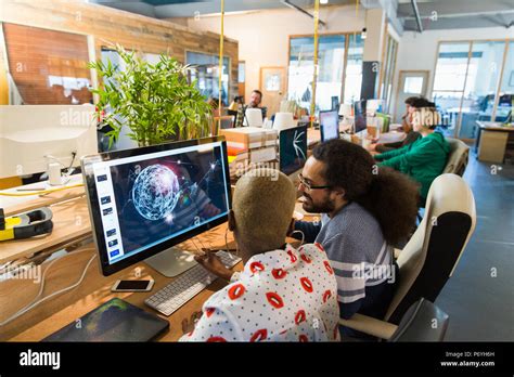 Graphic Designers Working In Open Plan Office Stock Photo Alamy