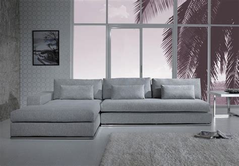 Elegant Gray Sectional Sofa With Chaise Idea With Soft Cushiosn Beneath Large Glass Window With Gray Area Rug 