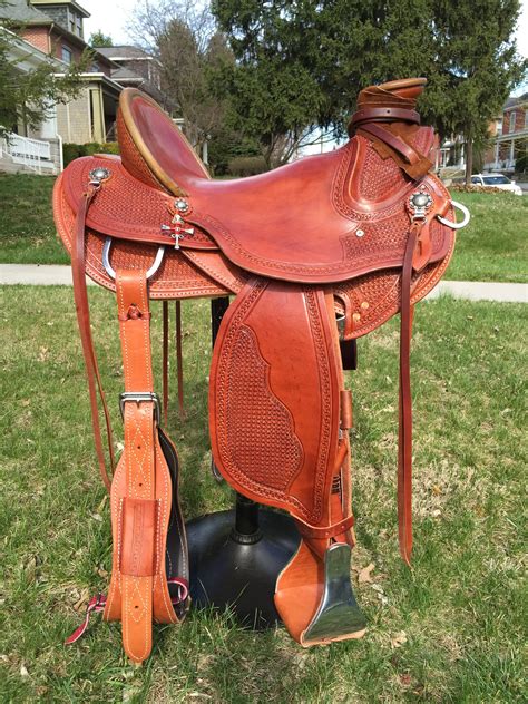 Wade #6 - Medium oil saddle with horseshoe nail cross hanging from