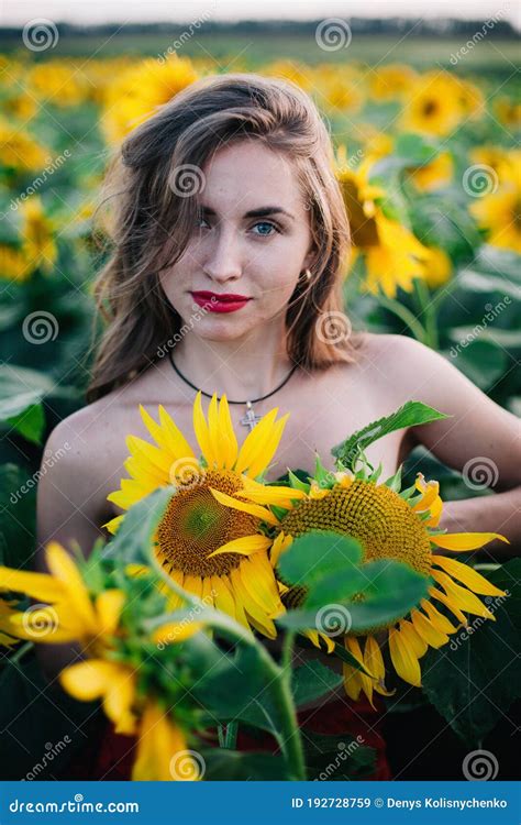 Young Slender Girl Without Clothes Is Covered With Sunflowers Stock