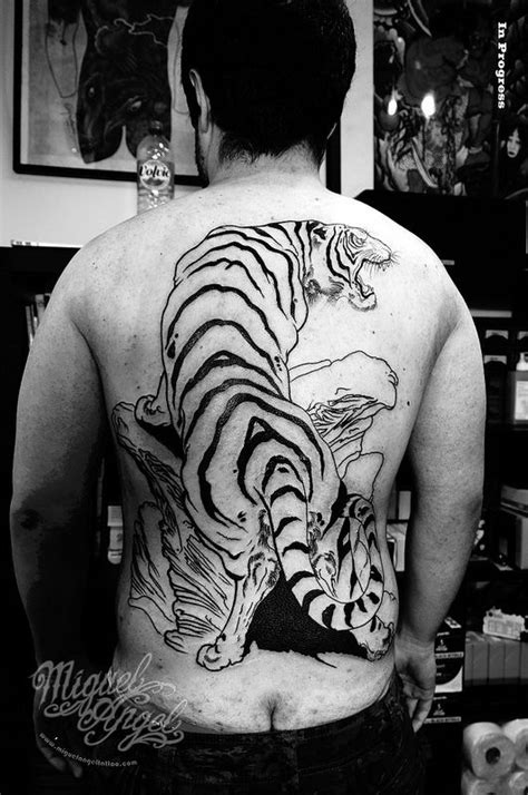 A Man With A Tiger Tattoo On His Back