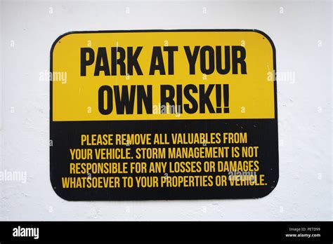 Park At Your Own Risk Sign On Wall Stock Photo Alamy