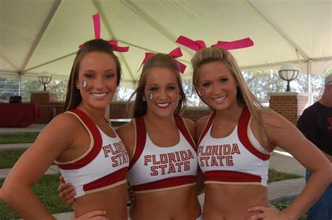Three Women In Red And White Cheerleader Outfits