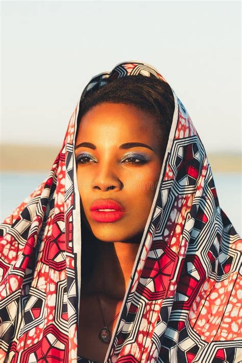 Close Up Portrait Of A Dark Skinned African American Girl In A National Costume At Sunset On