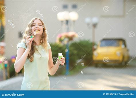 Happy Woman Blowing Soap Bubbles Focus On Soap Bubbles Stock Photo
