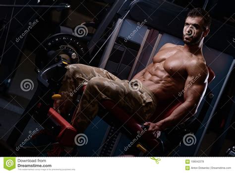 Strong Bodybuilder Athletic Men Pumping Up Muscles With Dum Stock Photo