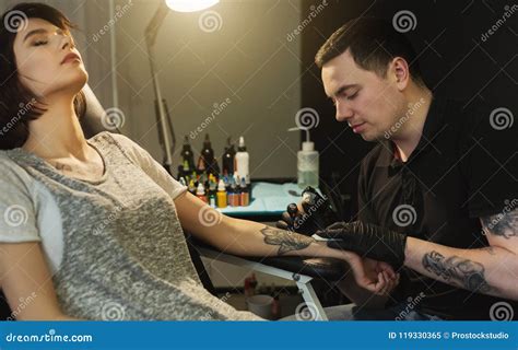 Painful Body Tattooing Process Master Working In Studio Stock Image