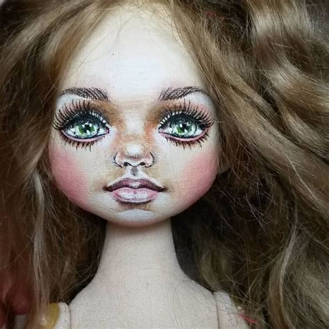 A Close Up Of A Doll With Long Brown Hair And Makeup On Its Face