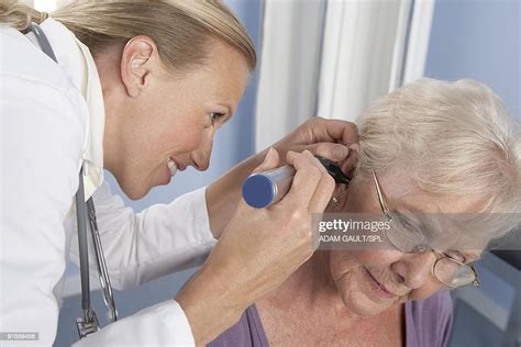 Ear Examination General Practitioner Using Otoscope To Examine Elderly