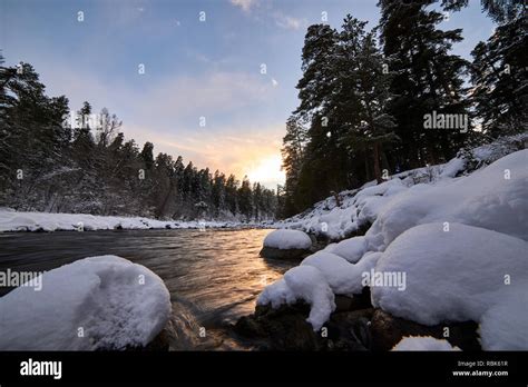 Mountain River With Snow And Green Water On The Sunset Bolshoy
