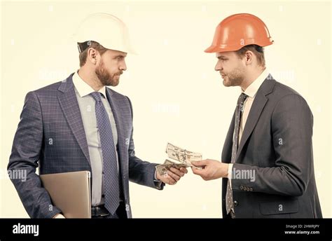 Investors Men In Suit And Safety Helmet Giving Or Taking Money And Hold