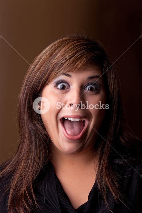 Woman With A Funny Look On Her Face Smiles Over A Dark Background Royalty Free Stock Image