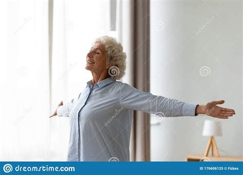overjoyed old woman stretch at home feeling positive stock image image of mature lifestyle