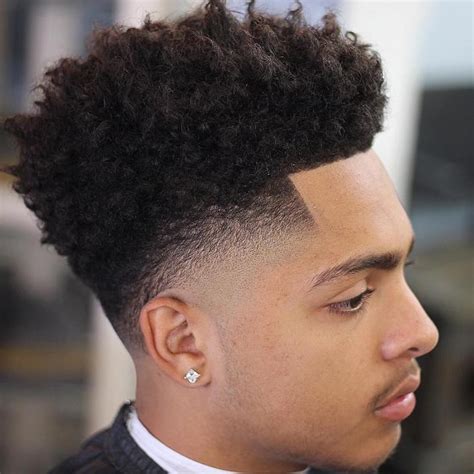 It is still a short afro hairstyle, but the top is actually longer than the back part, with curls sticking similar to the hairstyle above, but this particular shot afro haircut focuses completely on the top part. 15 Best Haircuts for African American Men 2020 : Cruckers
