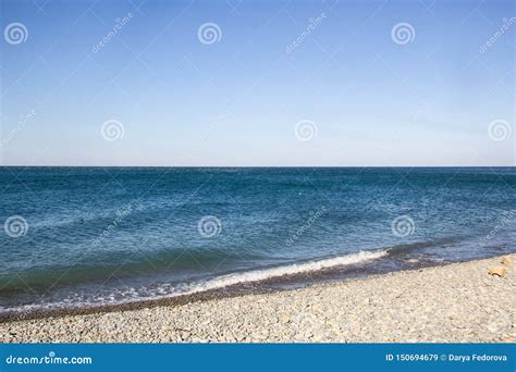 The Sea Foamy Waves On An Empty Pebble Beach Stock Image Image Of