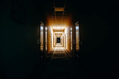 Dark Hallway With Peeling Paint On The Walls In An Abandoned Building