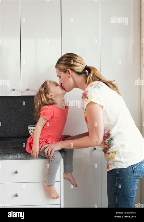 Mother Kissing Her Daughter Stock Photo Alamy