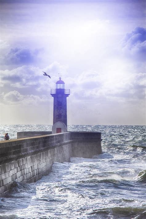 Lonely Lighthouse On The Pier In Porto City In Portugal Against Roaring