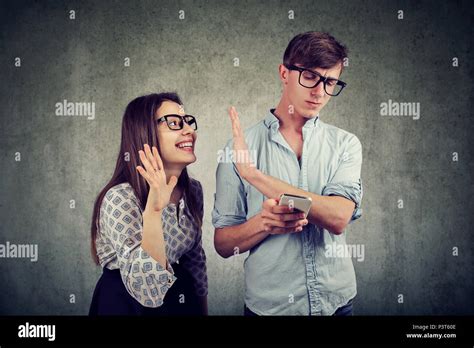 Annoying Woman Trying To Distract Young Handsome Man Ignoring Her While