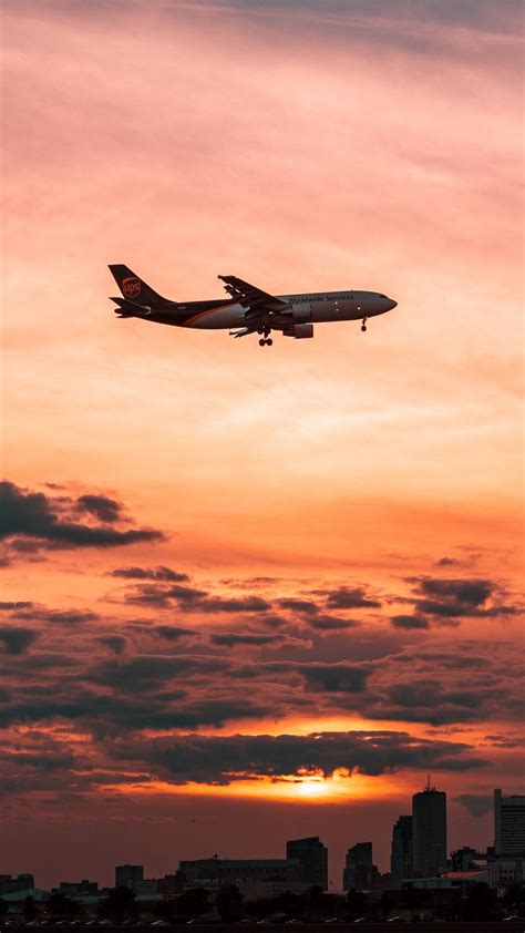 Download Wallpaper 938x1668 Airplane Sky Flight Clouds Sunset