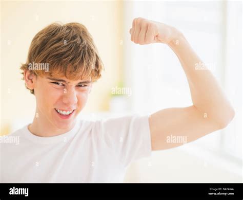 Teenage Boy 14 15 Flexing Muscles Stock Photo Alamy