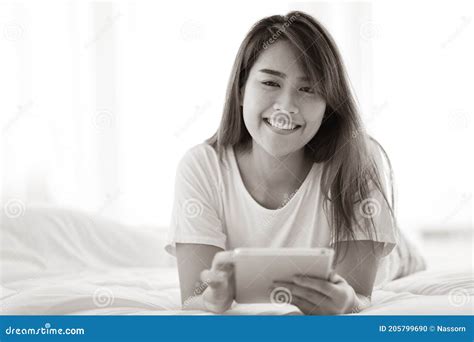 Portrait Of Beautiful Asian Woman Lying On Bed Enjoy Using Tablet Young Lady Resting In Bedroom