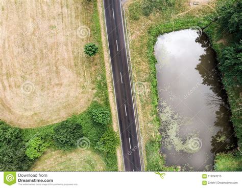 Aerial View Of A Small Pond Parallel To A Country Road In Saxony Anhalt