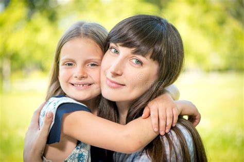 Cute Little Girl Hugging Her Mother Stock Photo Image Of Meadow