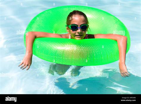 Girl Floating In Inner Tube In Pool Stock Photo Alamy