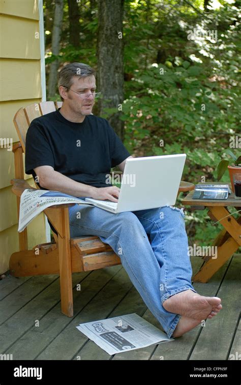 Man Sitting On Porch With Laptop Stock Photo Alamy