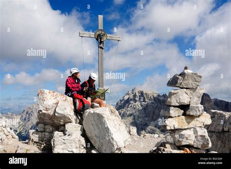 Climbers At The Summit Cross Via Ferrata Tour On Mt Paternkofel