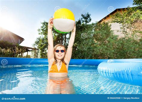 Girl Playing With Beach Ball In The Swimming Pool Stock Photo Image